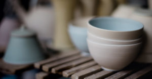 Stack of ceramic bowls in soft pastel colors, showcasing a minimalist and elegant design at Adagio Villa Resort.